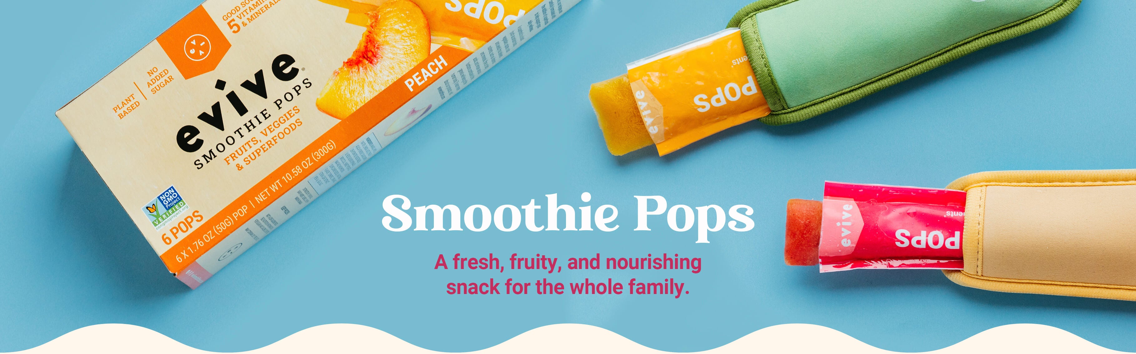 An overhead shot of colorful Evive Smoothie Bites, two product bags, and a white portable blender.